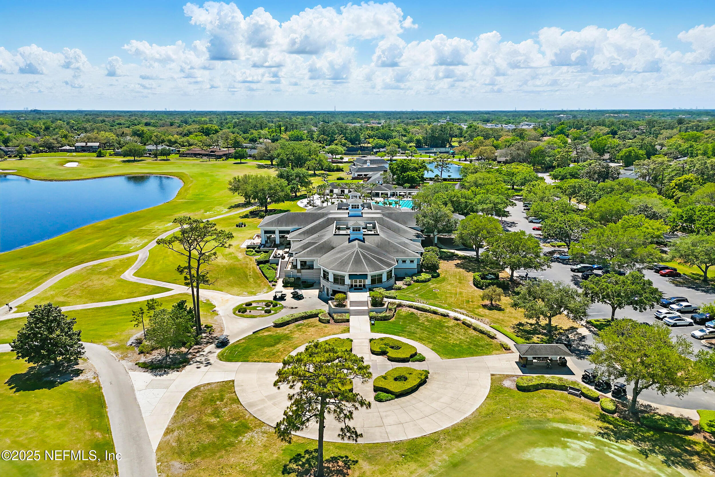 8007 Acorn Ridge Road Jacksonville, FL 32256 - Photo 74 of 76 a view of a swimming pool with a table and chairs potted plants and large tree