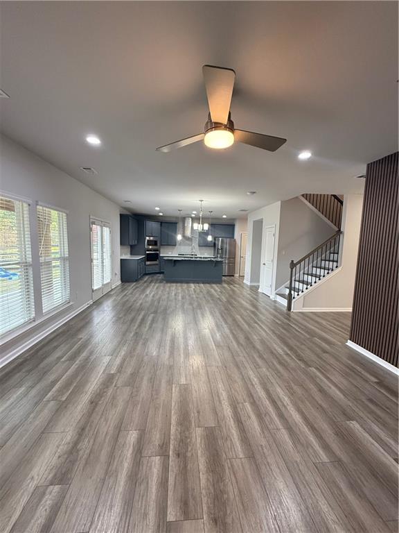 4610 Sandy Creek Drive Cumming, GA 30028 - Photo 14 of 49 a view of empty room with wooden floor and fan