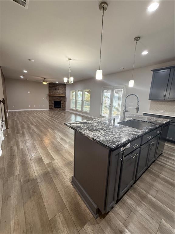 4610 Sandy Creek Drive Cumming, GA 30028 - Photo 15 of 49 a kitchen with stainless steel appliances granite countertop a sink a stove and a wooden floors