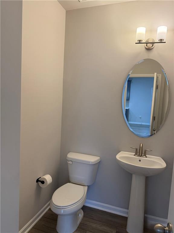 4610 Sandy Creek Drive Cumming, GA 30028 - Photo 22 of 49 a bathroom with a toilet a sink and mirror