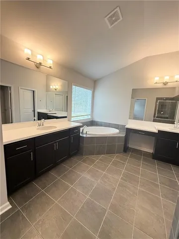 a room with a sink cabinets and appliances