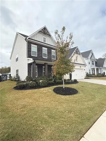 a front view of a house with yard and garage