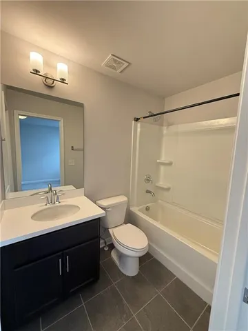 a view of an empty room and a ceiling fan