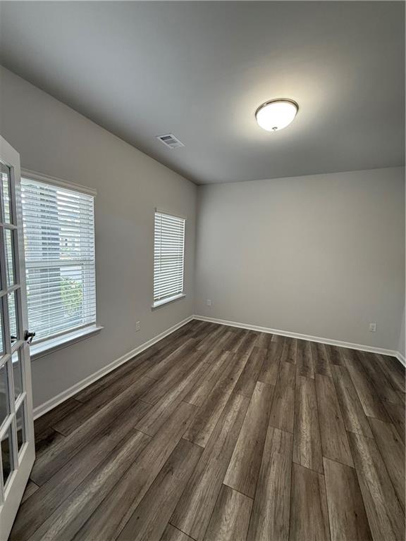 4610 Sandy Creek Drive Cumming, GA 30028 - Photo 6 of 49 an empty room with wooden floor and windows