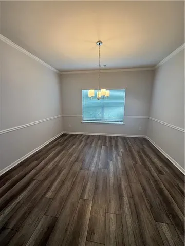 a view of a room with wooden floor and windows