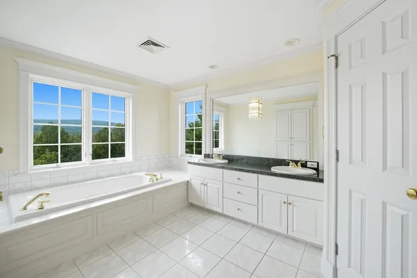 a bathroom with bathtub and window