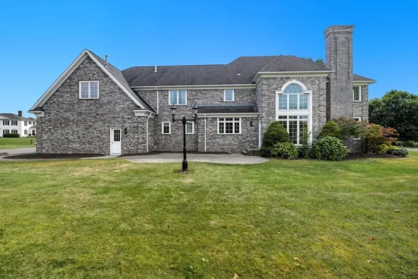 an aerial view of a house with a yard and lake view