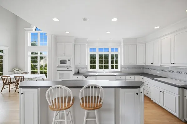 a kitchen with stainless steel appliances granite countertop a sink and dishwasher with wooden floor