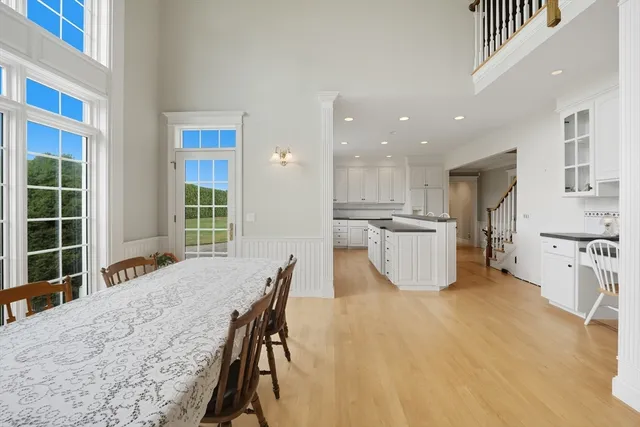 a view of a kitchen with furniture and wooden floor