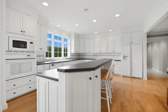 a kitchen with granite countertop a sink stove and refrigerator