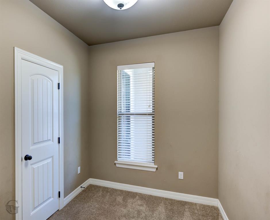 922 Antler Drive Haughton, LA 71037 - Photo 20 of 24 Textured carpet flooring, neutral paint tones, contemporary overhead lighting, window with blinds, and white trim throughout