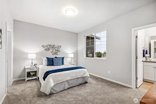 a bedroom with a bed and a lamp