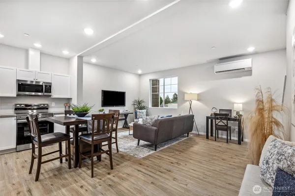 a living room with furniture a flat screen tv and a fireplace