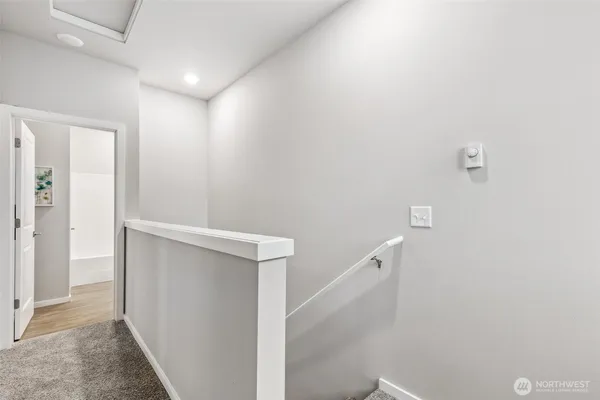 a bedroom with a bed and a lamp on table