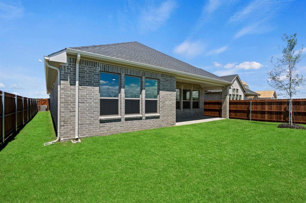 1792 Monarch Way Oak Point, TX 75068 - Photo 25 of 26 a front view of a house with a garden