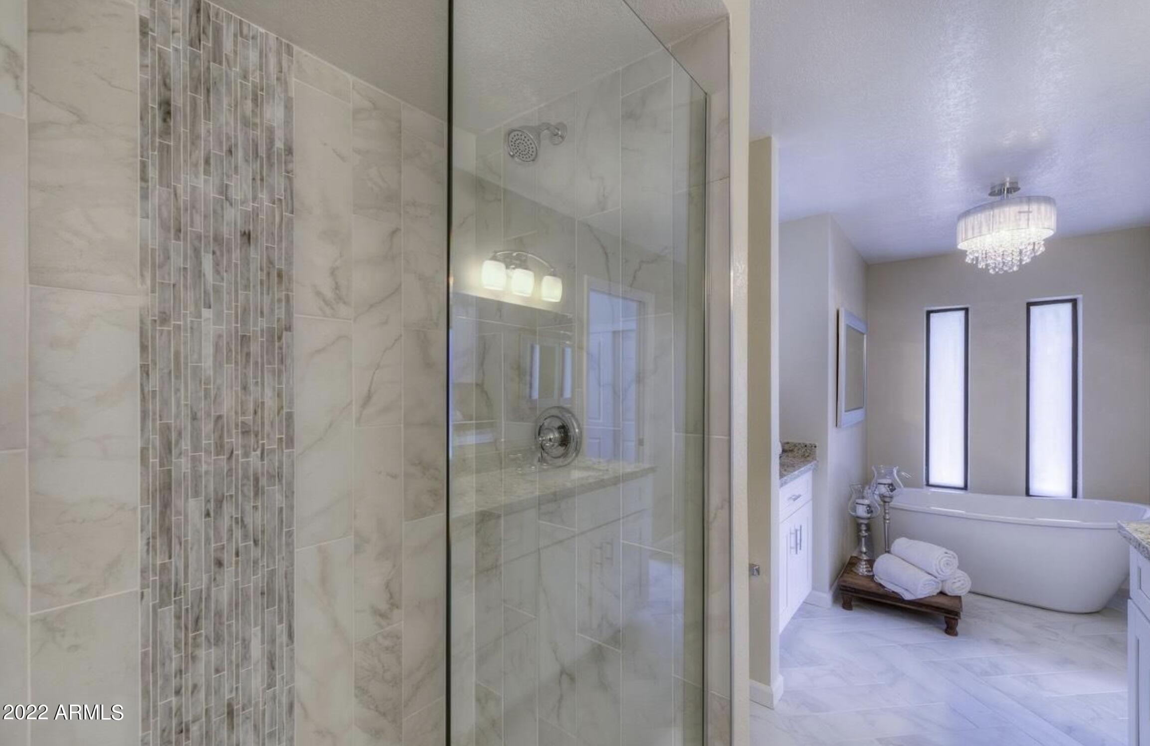 6609 East Phelps Road Scottsdale, AZ 85254 - Photo 58 of 83 a bathroom with a mirror and a shower