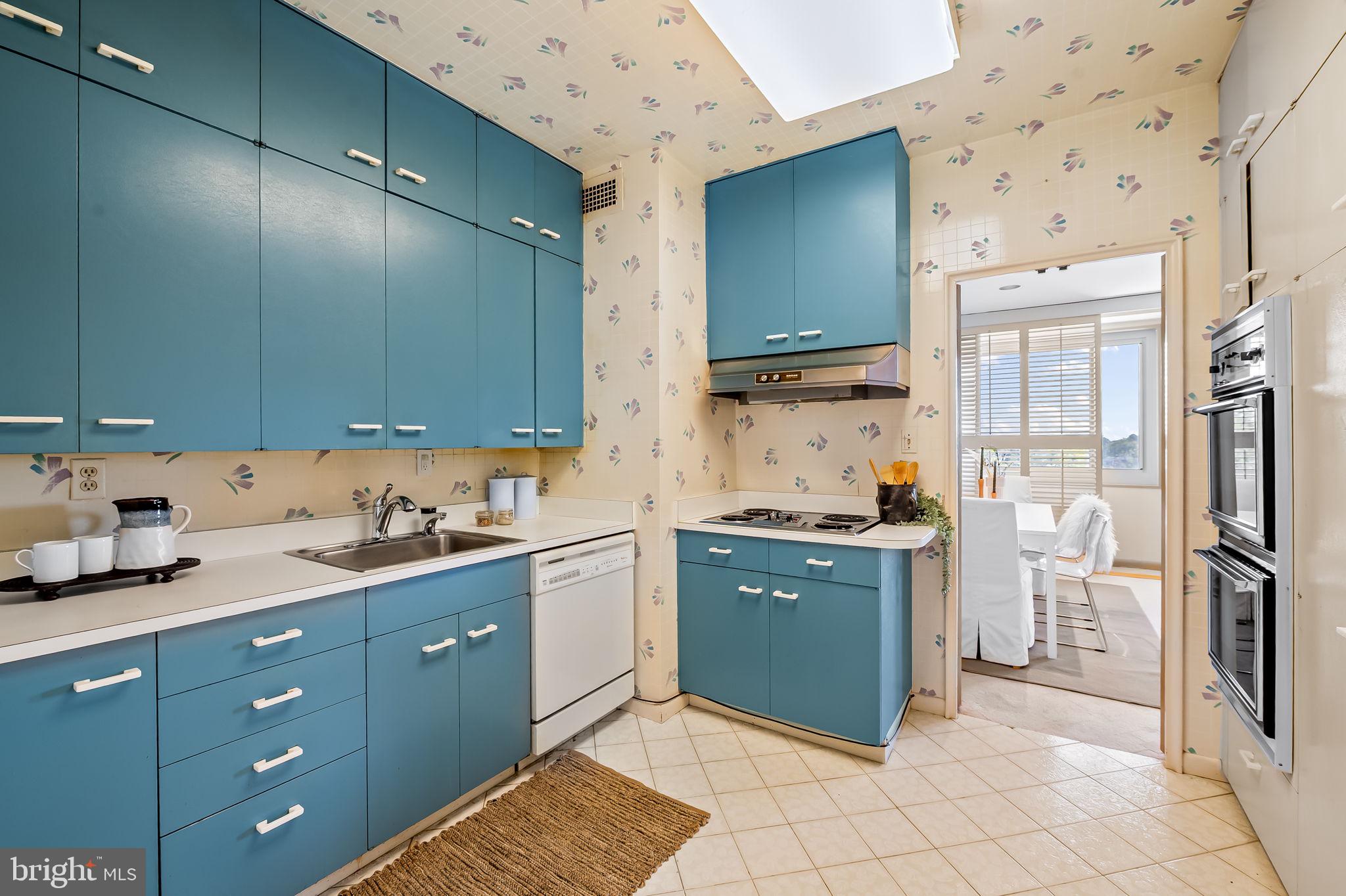 11 Slade Avenue, Unit 604 Baltimore, MD 21208 - Photo 16 of 36 a kitchen with stainless steel appliances granite countertop a sink stove and refrigerator
