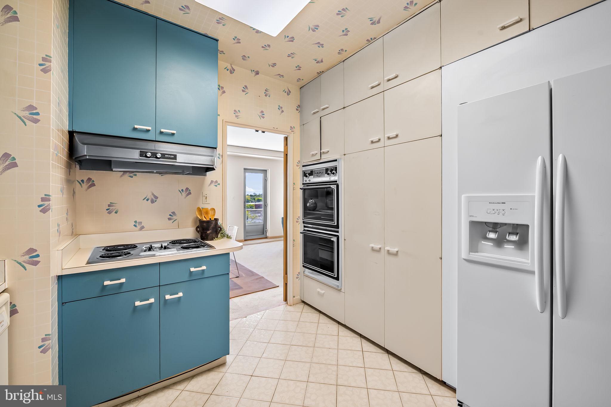 11 Slade Avenue, Unit 604 Baltimore, MD 21208 - Photo 17 of 36 a kitchen with stainless steel appliances a refrigerator sink and cabinets