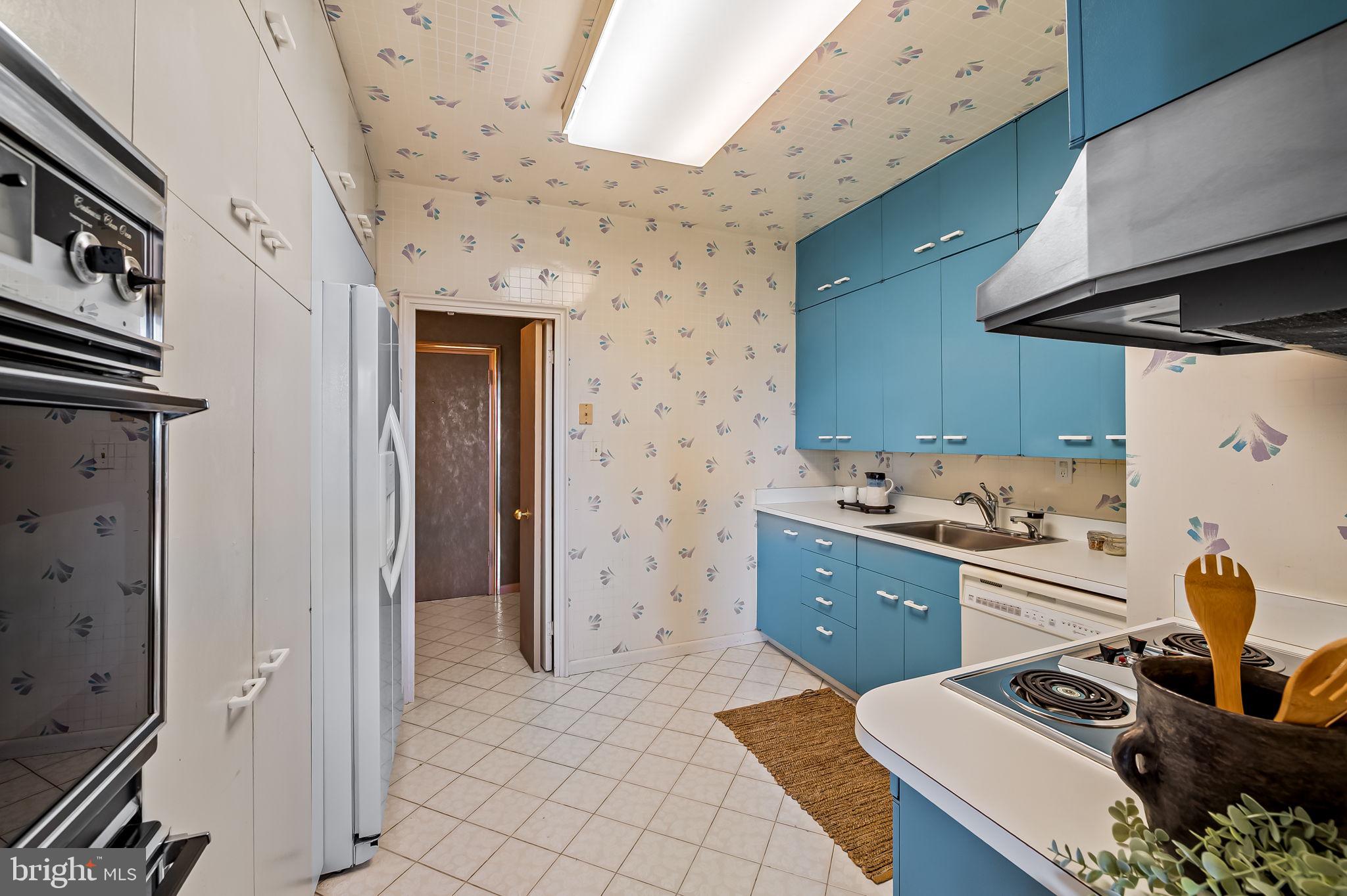 11 Slade Avenue, Unit 604 Baltimore, MD 21208 - Photo 19 of 36 a kitchen with a sink a stove and refrigerator