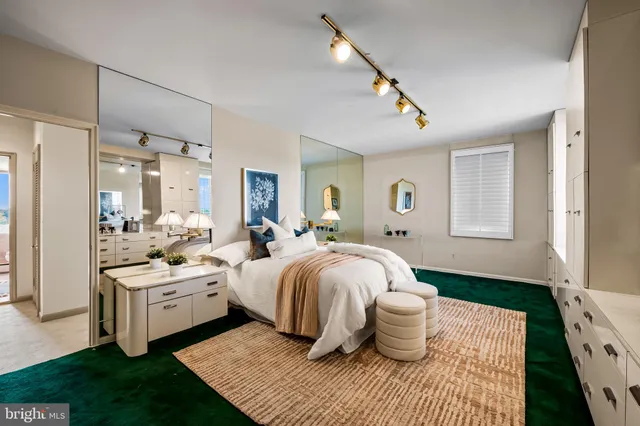 a bedroom with a white bed and a chandelier