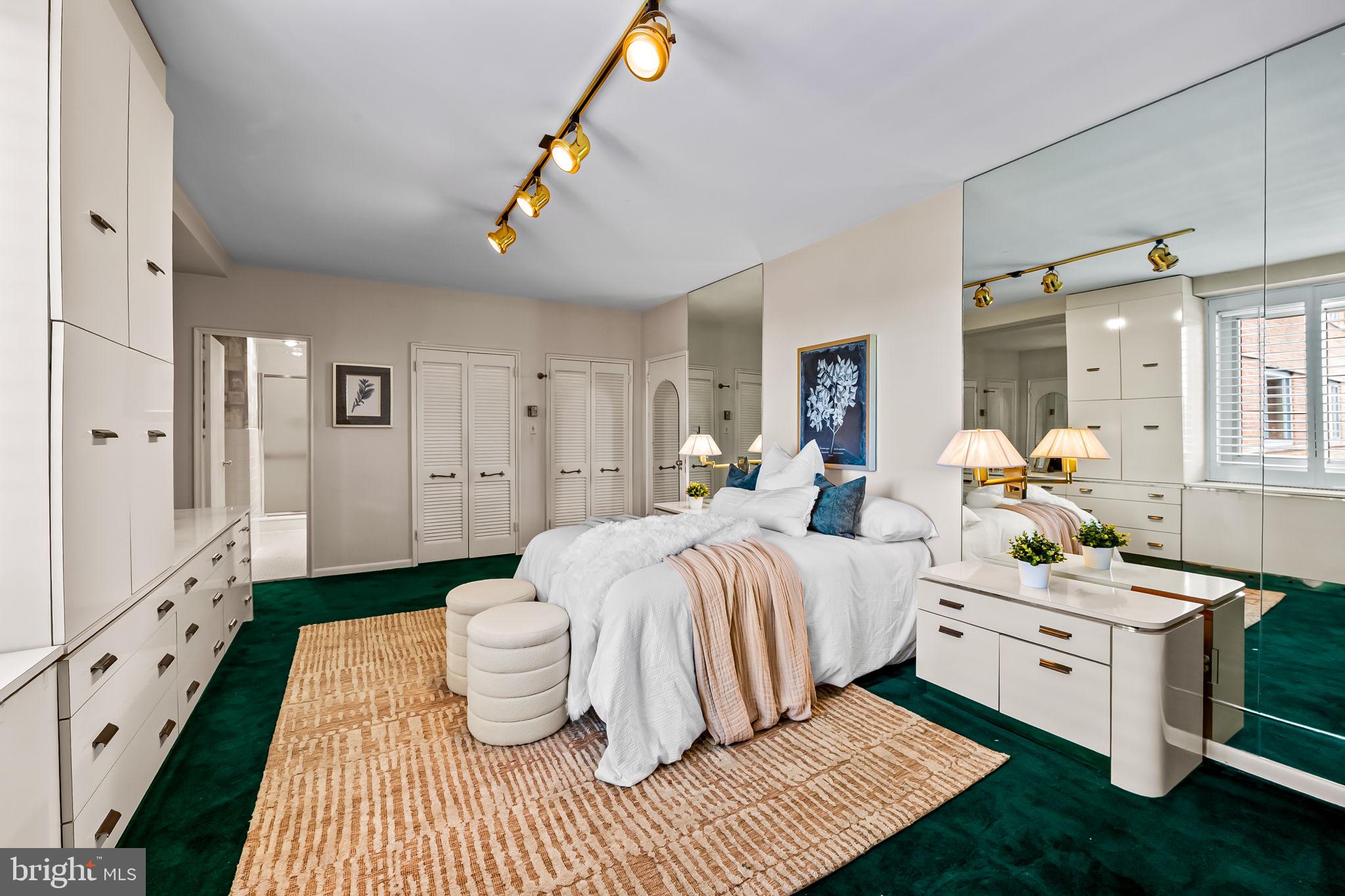 11 Slade Avenue, Unit 604 Baltimore, MD 21208 - Photo 21 of 36 a bedroom with a white bed and a chandelier