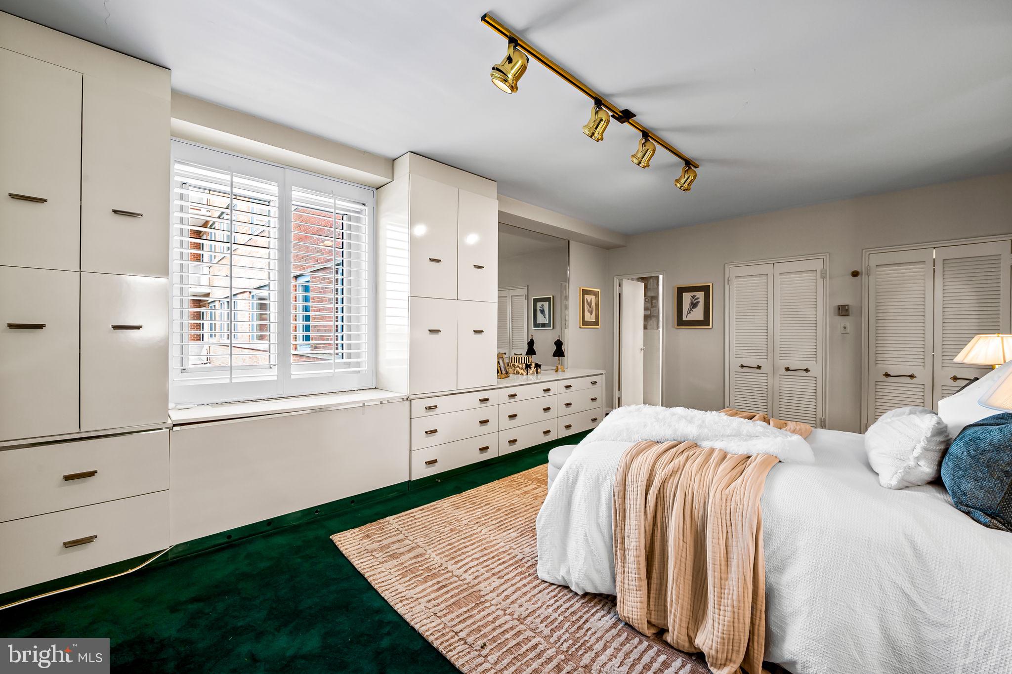 11 Slade Avenue, Unit 604 Baltimore, MD 21208 - Photo 23 of 36 a bedroom with a bed and a window