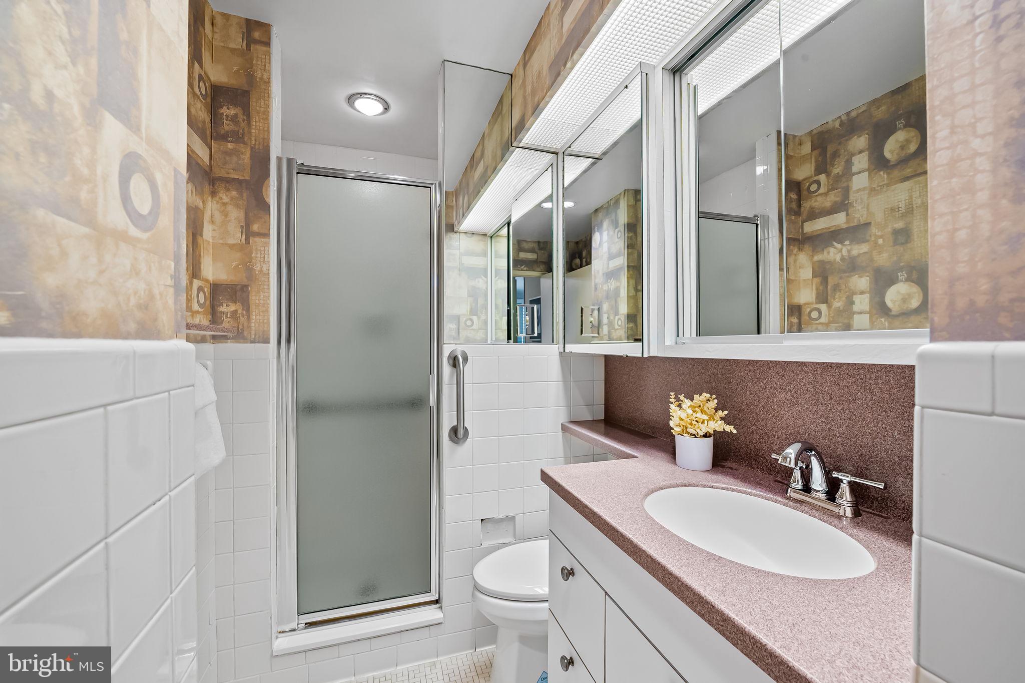 11 Slade Avenue, Unit 604 Baltimore, MD 21208 - Photo 25 of 36 a bathroom with a sink toilet and shower