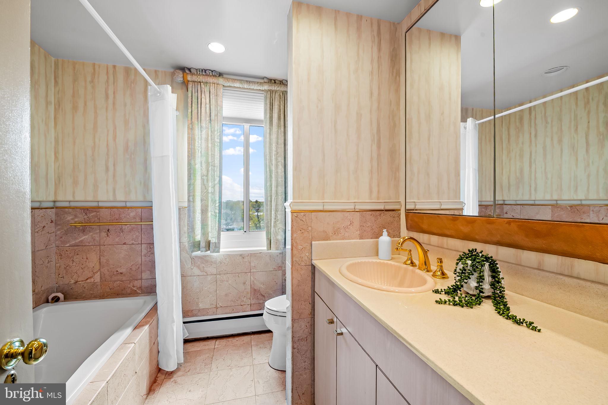 11 Slade Avenue, Unit 604 Baltimore, MD 21208 - Photo 29 of 36 a bathroom with a bathtub and a sink