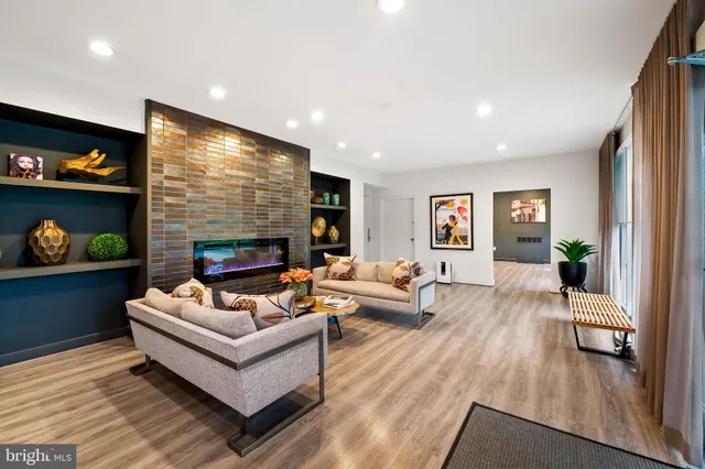 a living room with furniture kitchen view and a table