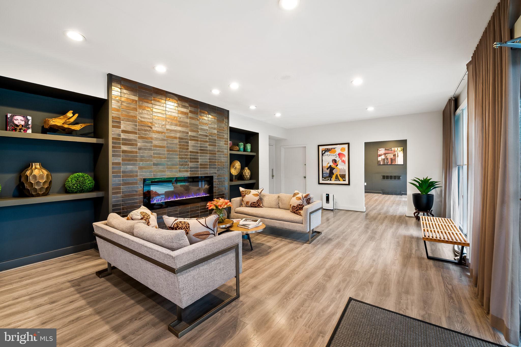 11 Slade Avenue, Unit 604 Baltimore, MD 21208 - Photo 32 of 36 a living room with fireplace furniture and a flat screen tv