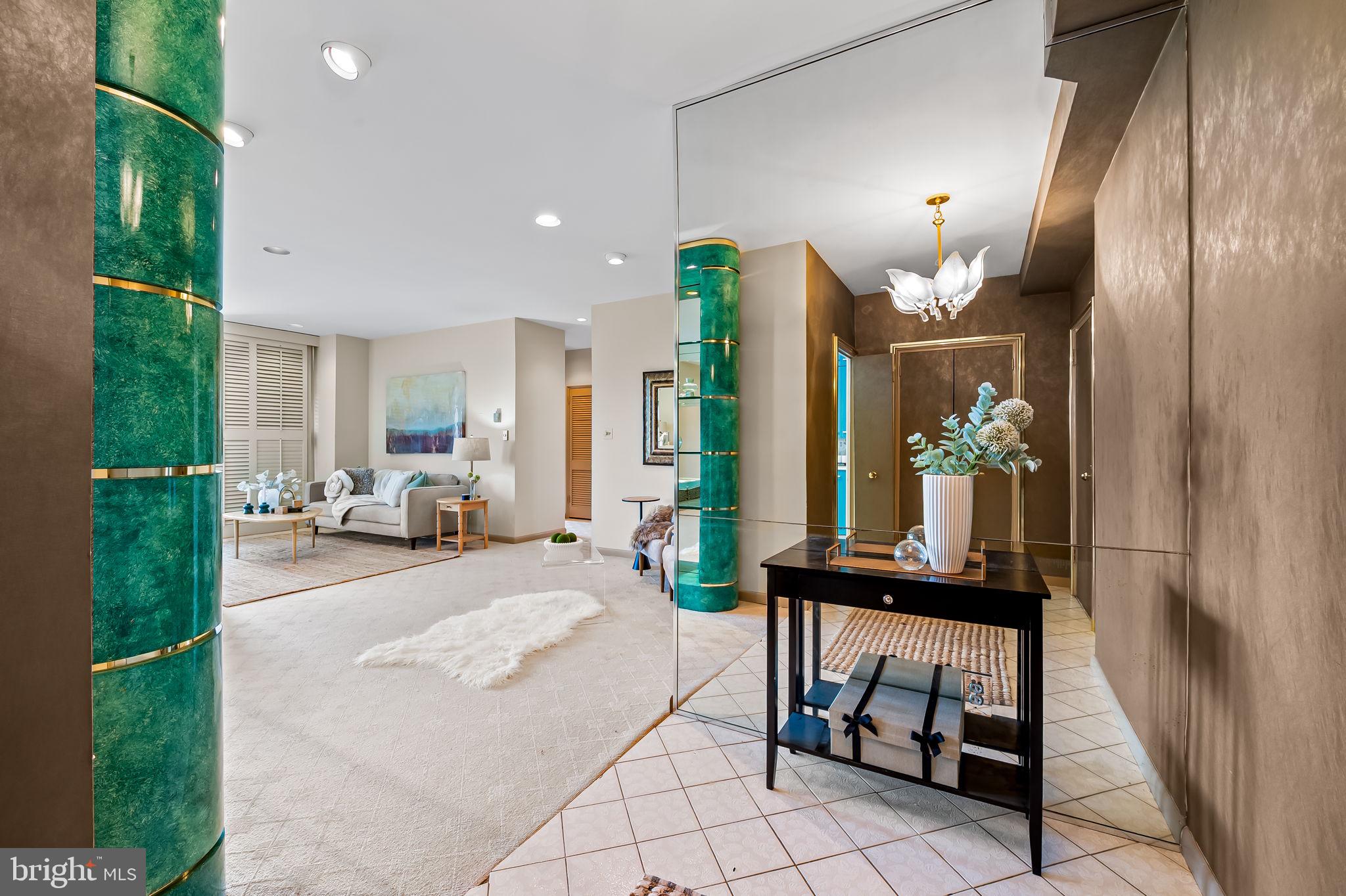 11 Slade Avenue, Unit 604 Baltimore, MD 21208 - Photo 6 of 36 a lobby with furniture and a potted plant
