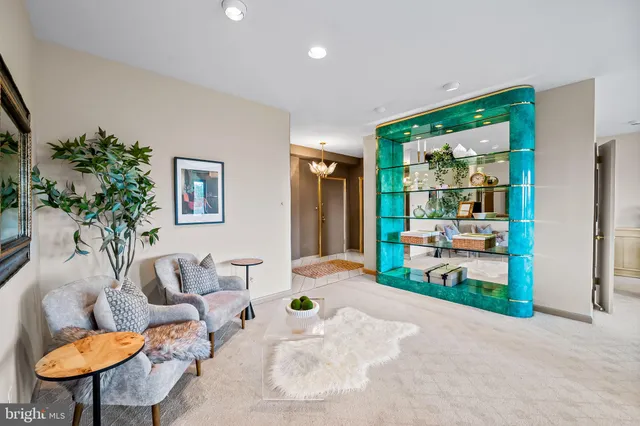a living room with furniture a window and a potted plant