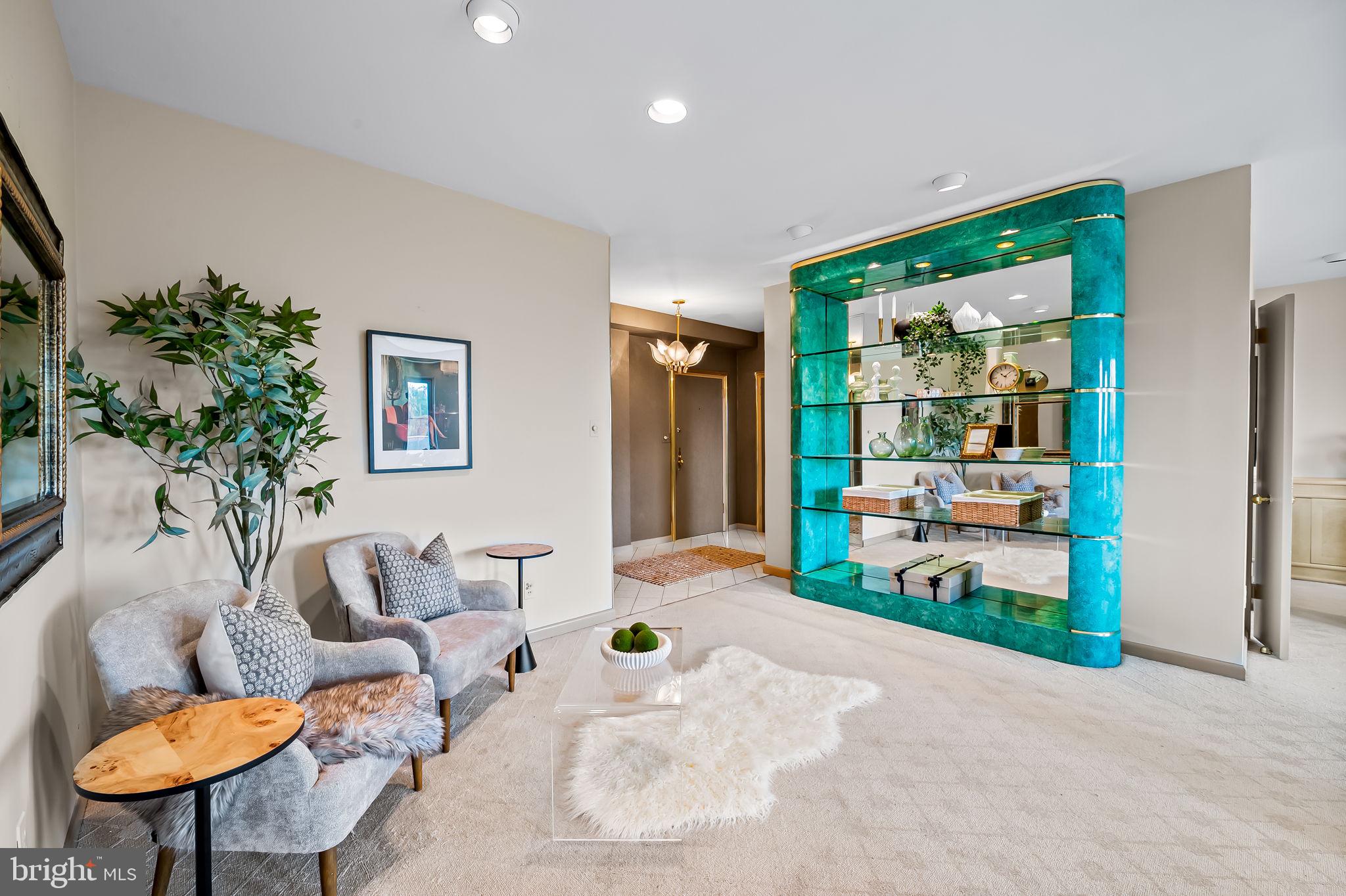 11 Slade Avenue, Unit 604 Baltimore, MD 21208 - Photo 7 of 36 a living room with furniture and a potted plant