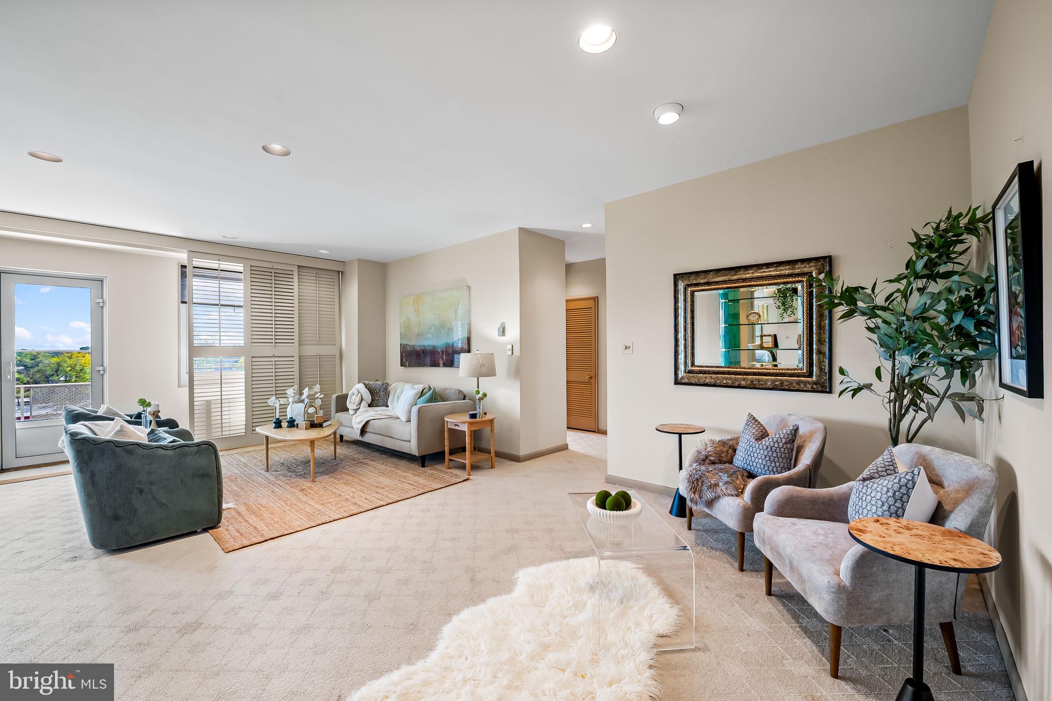 11 Slade Avenue, Unit 604 Baltimore, MD 21208 - Photo 9 of 36 a living room with furniture and a large window