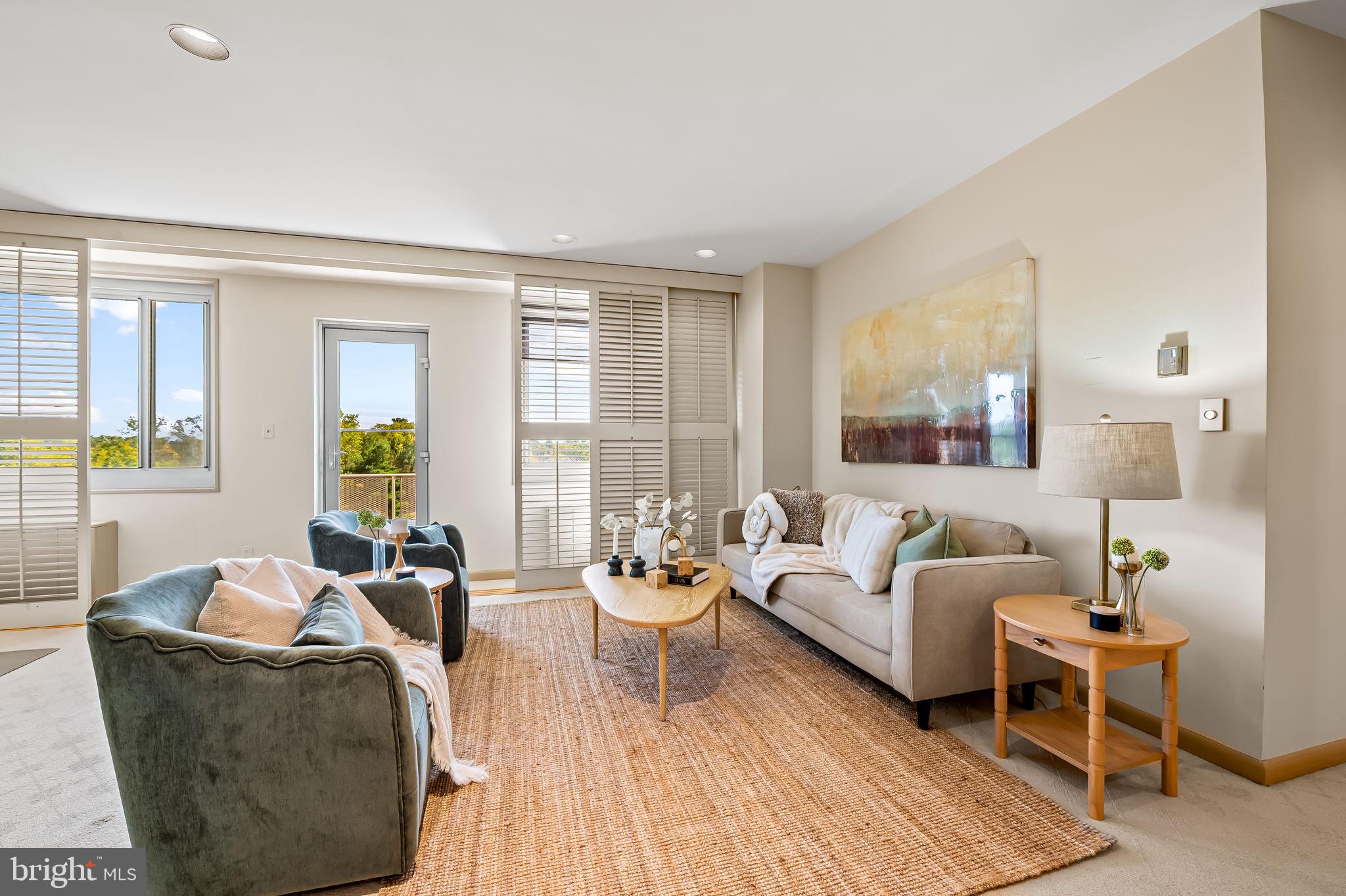 11 Slade Avenue, Unit 604 Baltimore, MD 21208 - Photo 10 of 36 a living room with furniture and a large window