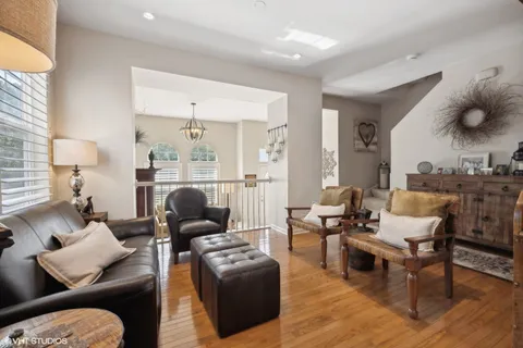 a living room with furniture and wooden floor