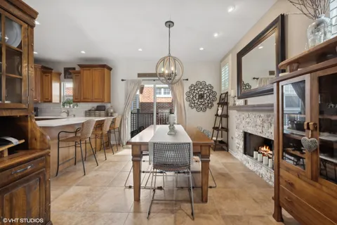 a dining room with furniture a fireplace and chandelier