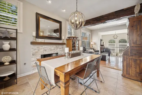 a view of a dining room with furniture and chandelier