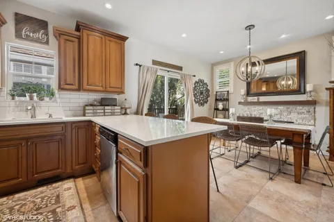 a kitchen with a stove a sink and a refrigerator