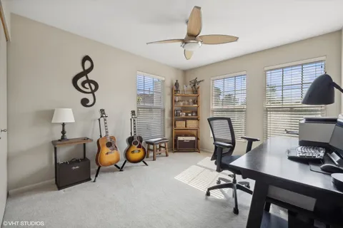 a spacious bedroom with a bed and a chandelier
