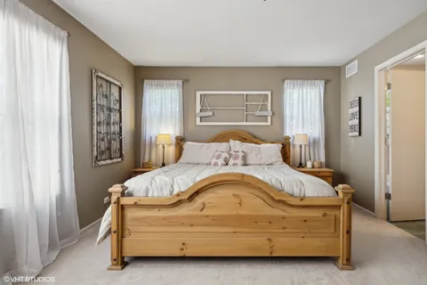 a bedroom with a large bed and a large window