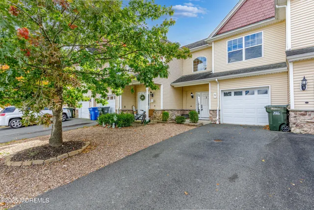 a front view of a house with a yard and a garage
