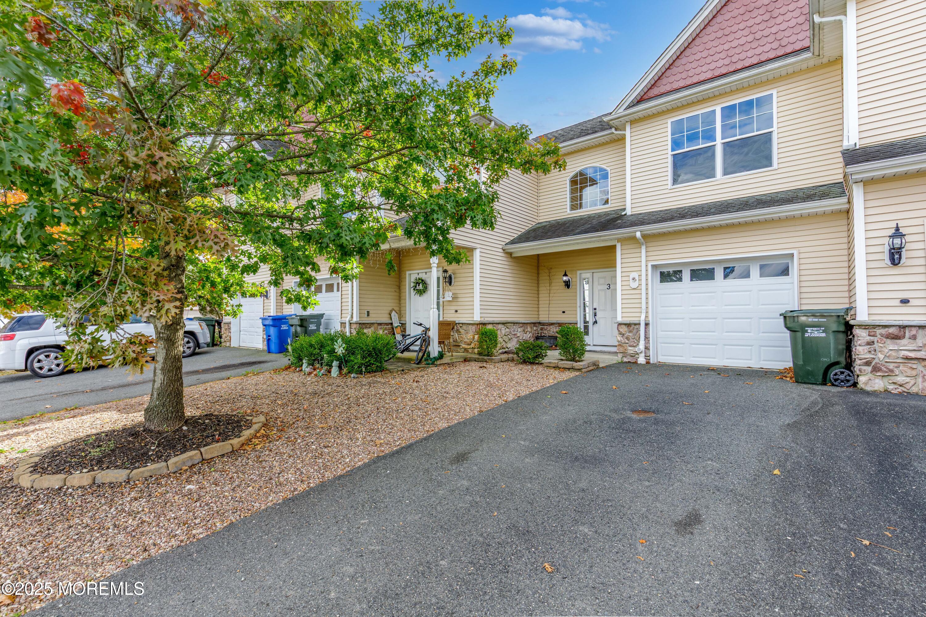 100 Pine Street, Unit 3 Lakehurst, NJ 08733 - Photo 1 of 20 a front view of a house with a yard and a garage