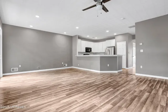 a view of a kitchen with a sink and a refrigerator