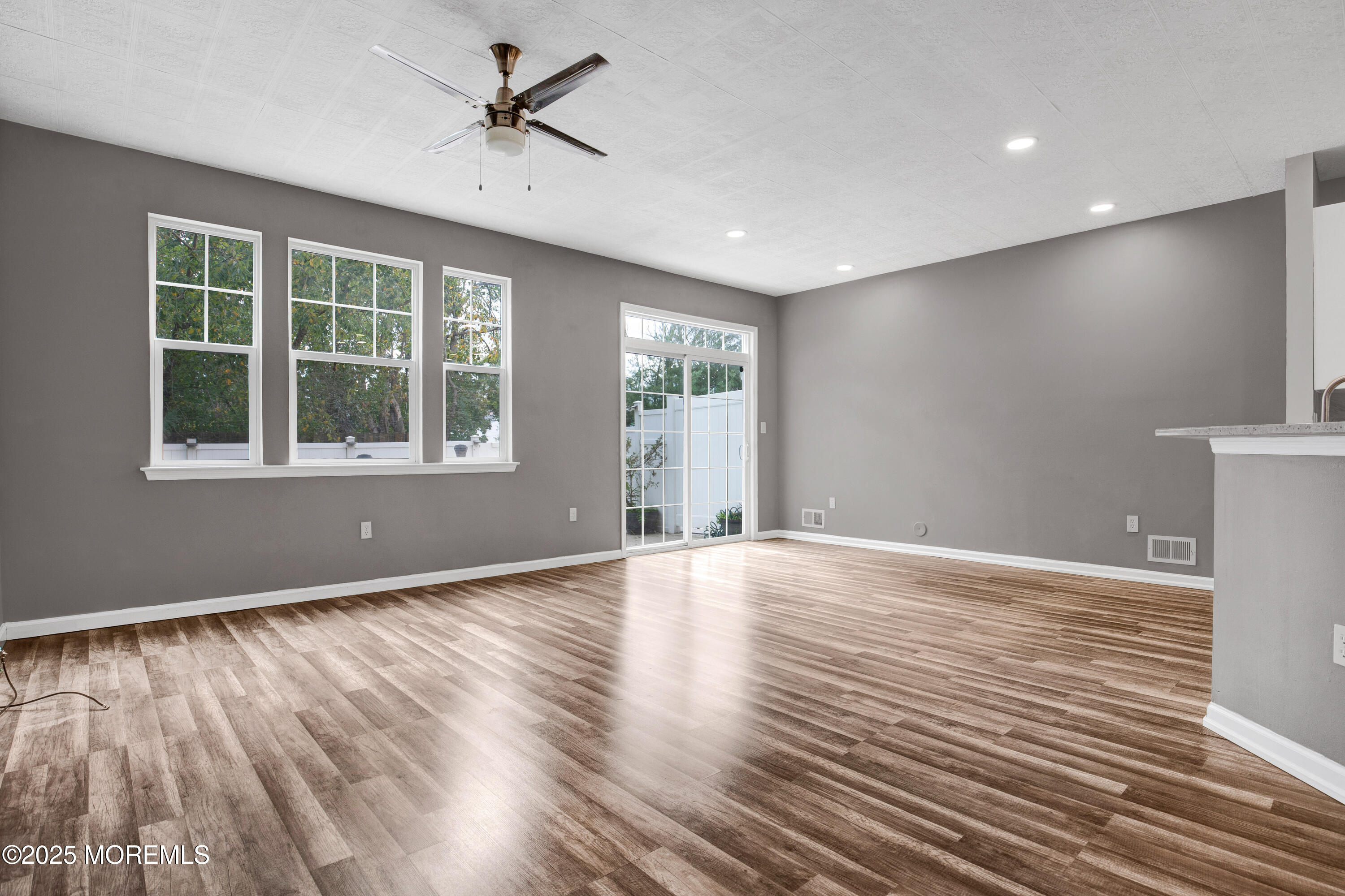 100 Pine Street, Unit 3 Lakehurst, NJ 08733 - Photo 7 of 20 a view of an empty room with wooden floor and a window