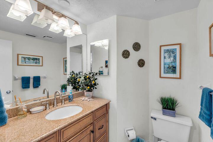 140 Aregood Lane, Unit C2 Islamorada, FL 33036 - Photo 17 of 49 a bathroom with a granite countertop sink mirror and toilet
