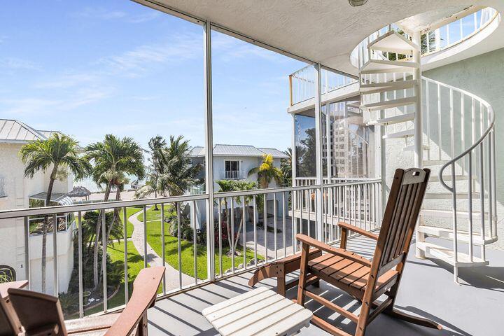 140 Aregood Lane, Unit C2 Islamorada, FL 33036 - Photo 21 of 49 a view of a balcony with wooden floor and outdoor seating