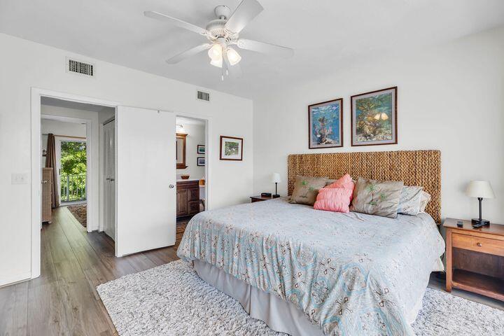 140 Aregood Lane, Unit C2 Islamorada, FL 33036 - Photo 24 of 49 a bedroom with a large bed and a chandelier