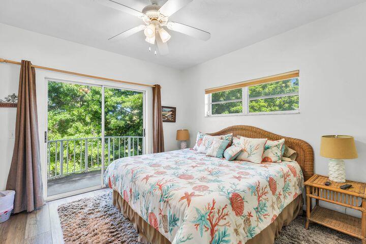 140 Aregood Lane, Unit C2 Islamorada, FL 33036 - Photo 25 of 49 a bedroom with a large bed and a window