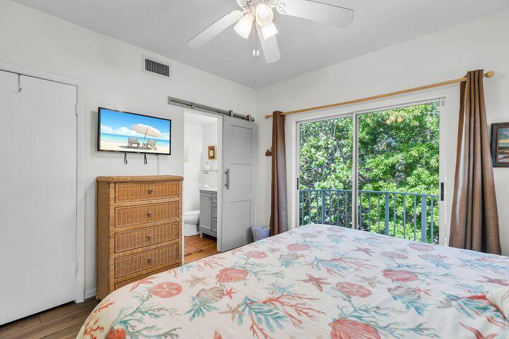 140 Aregood Lane, Unit C2 Islamorada, FL 33036 - Photo 26 of 49 a bedroom with a bed and a large window